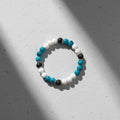 Teal agate, white howlite and black lava stone beaded bracelet