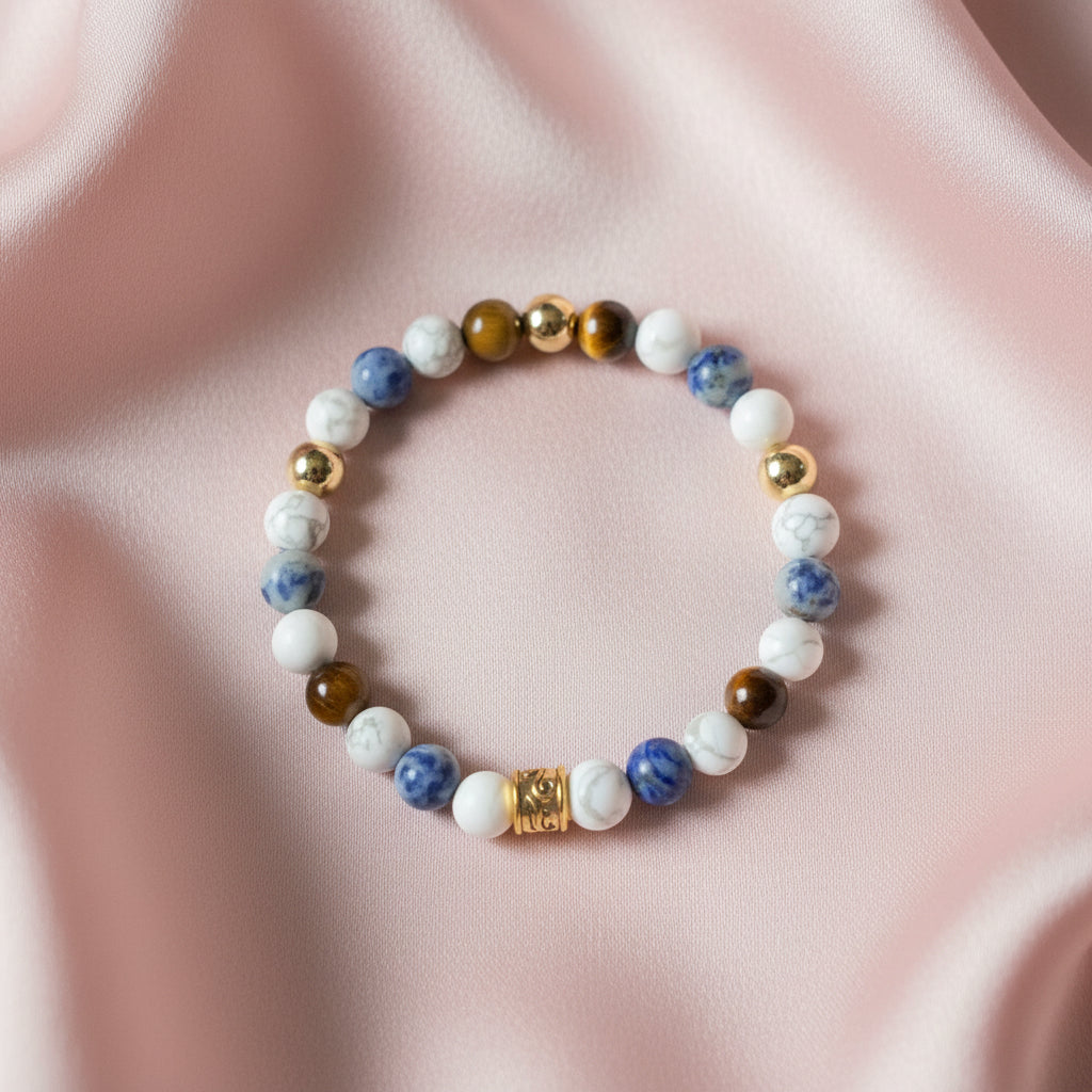Matte black onyx and red tiger's eye beaded stretch bracelet with gold barrel spacers