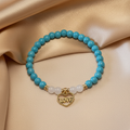 Turquoise Howlite & White Jade Love Charm Bracelet – Gold Background